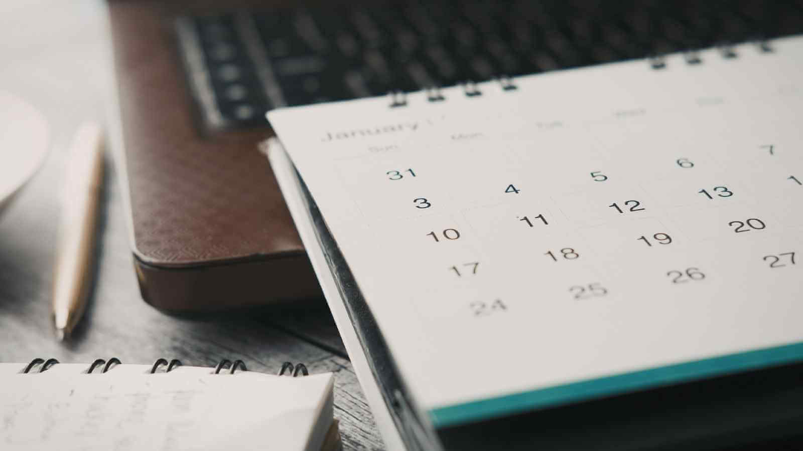 Woman coach planning a $5K month using execution standards and business systems