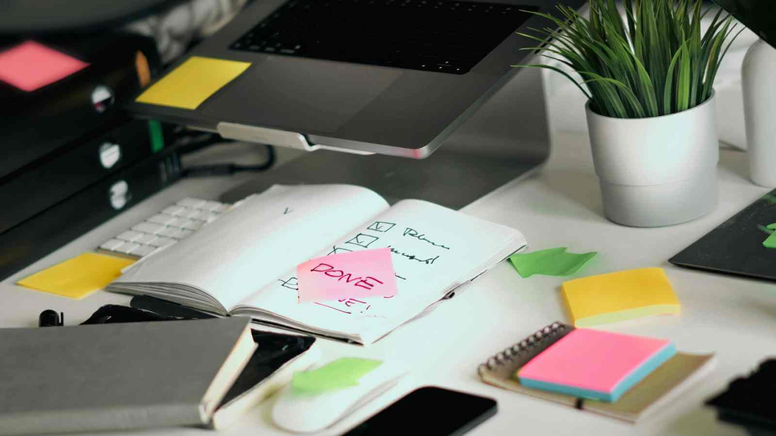 Focused female entrepreneur at a clean desk working on her business operating standards to get out of a slump.