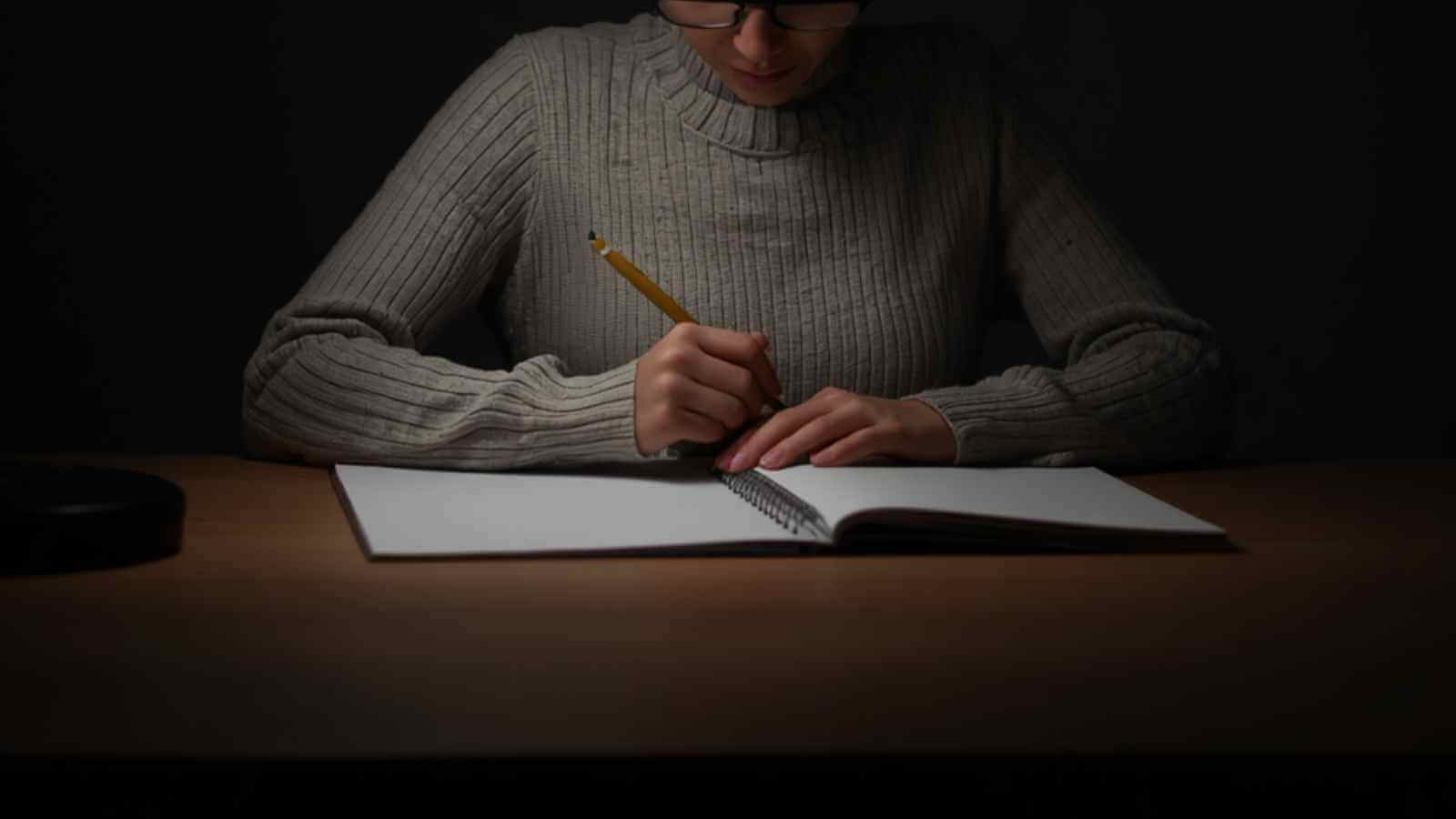 A professional woman coach at a high-end desk, closing a laptop to focus on business implementation over learning.